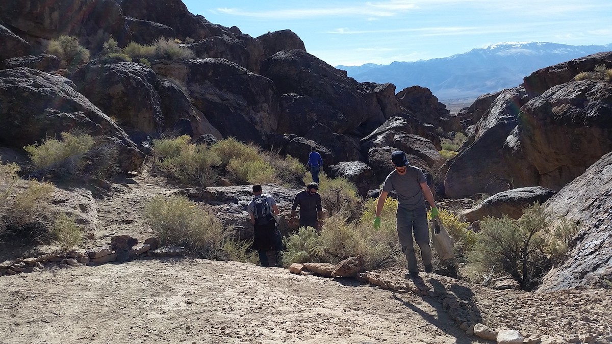 Hikers exploring the grounds and boulders of Volcanic Tablelands