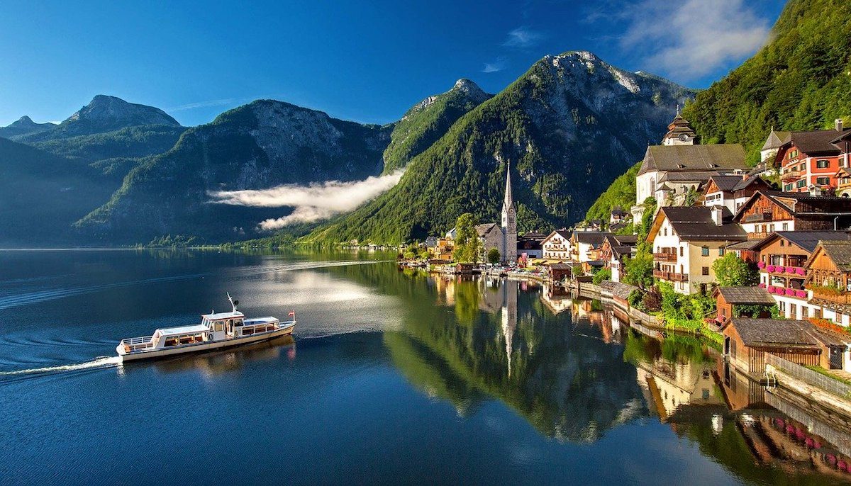 A boat cruises along the stunning Hallstatt Lake in Austria A boat cruises along the stunning Hallstatt Lake in Austria