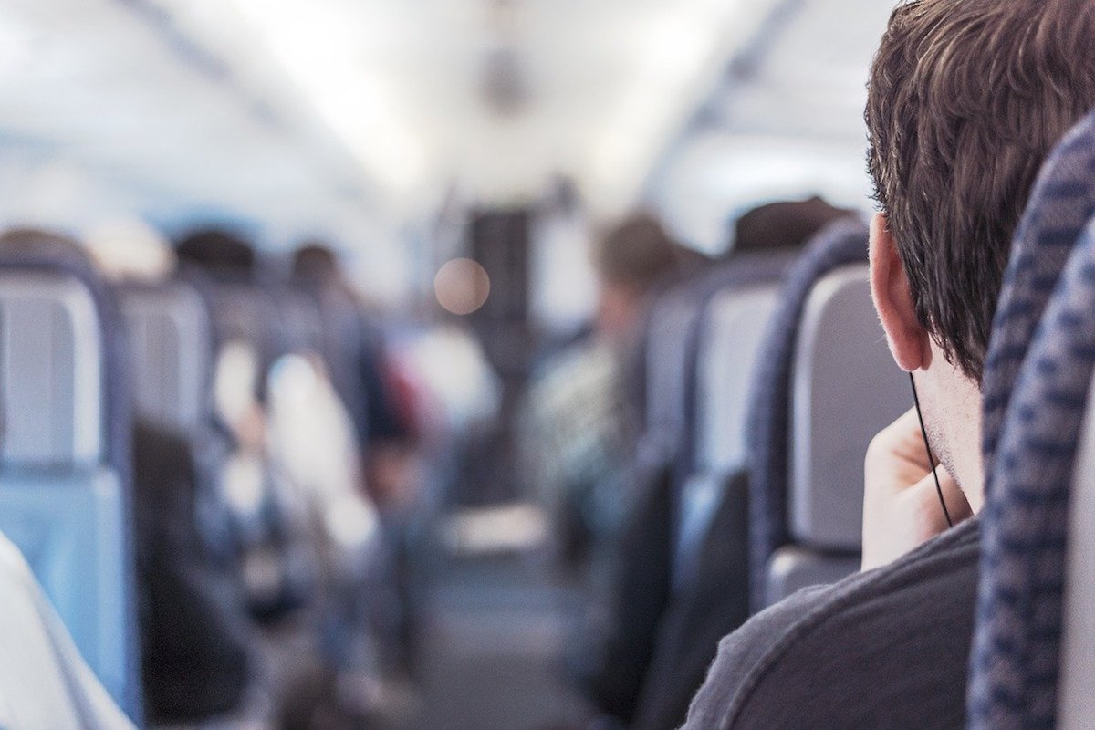 Airplane passenger sitting on aisle seat