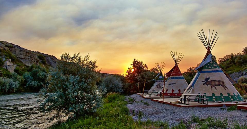 Teepees pictured against the sunrise