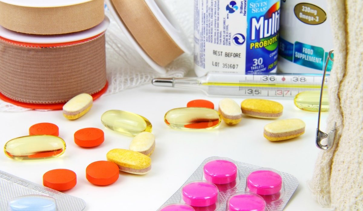 Medicine pills and emergency equipment on a table Medicine pills and emergency equipment on a table