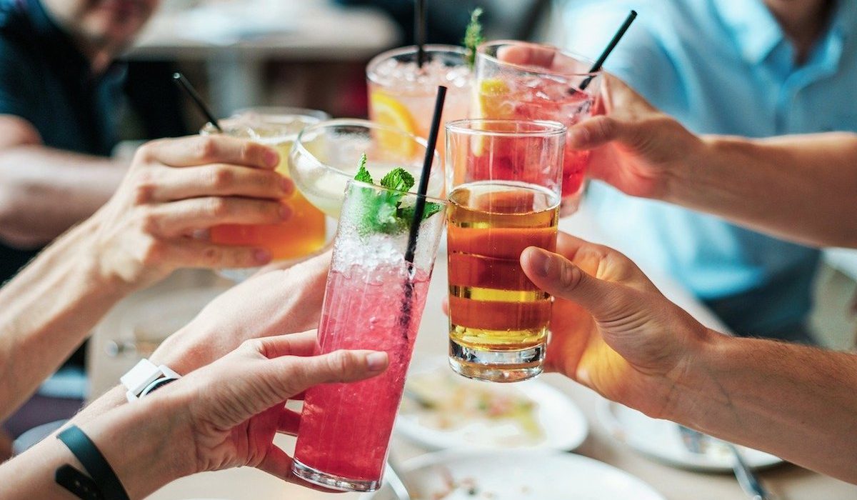People holding a variety of cocktails People holding a variety of cocktails