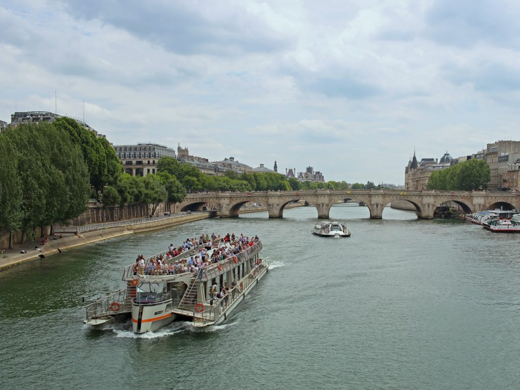 Open top boat cruising on the Seine River