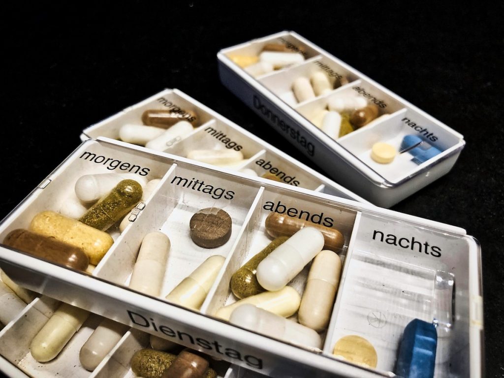 White pill organizer with German labels