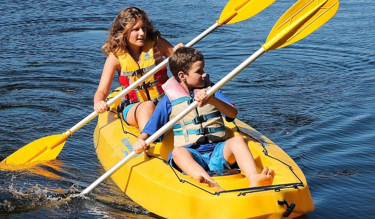 Mother and son on a yellow tandem kayak Mother and son on a yellow tandem kayak