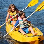 Mother and son on a yellow tandem kayak
