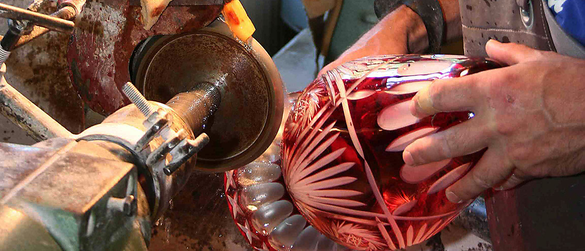 a red vase being polished at Dorotheenhütte Museum, Black Forest