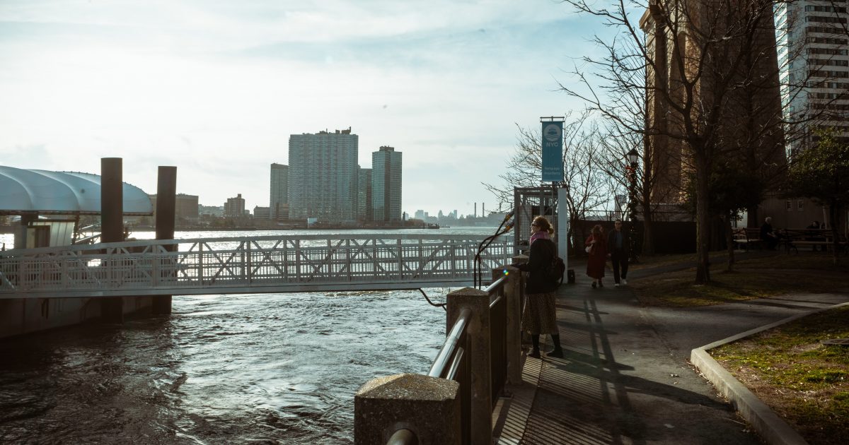 Tourist overlooking the East River from Roosevelt Island