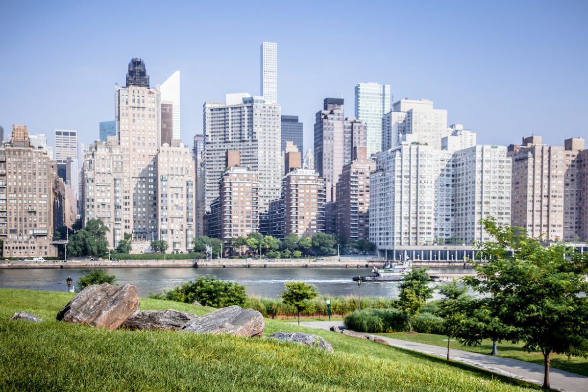 Beautiful Roosevelt Island park with Manhattan, New York City in background during sunny summer day