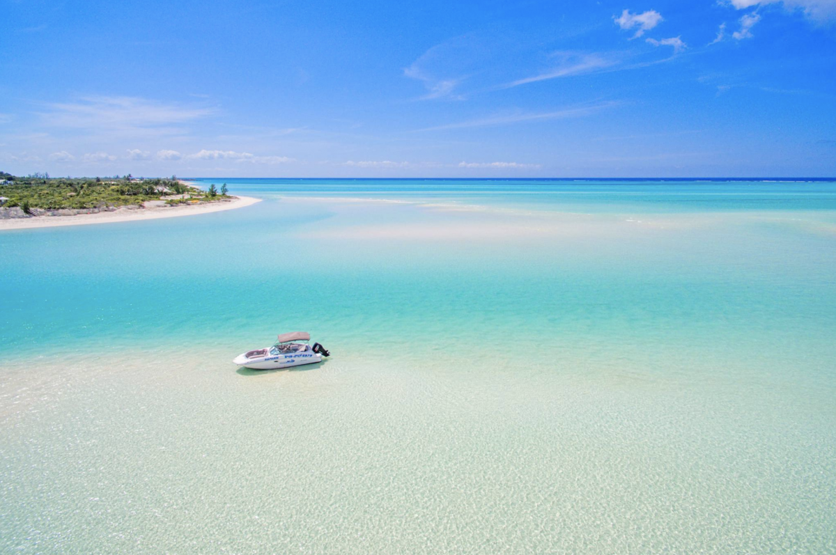 a yacht in a calm sandy point beach a yacht in a calm sandy point beach