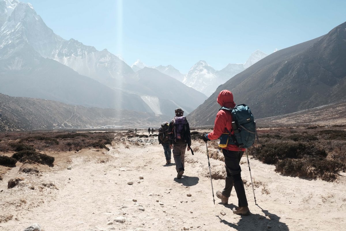 a group of trekkers in a rocky trail a group of trekkers in a rocky trail