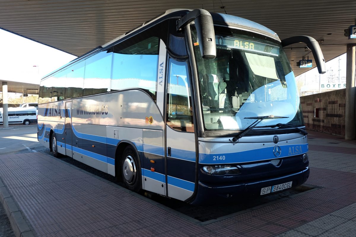 a parked blue and white bus