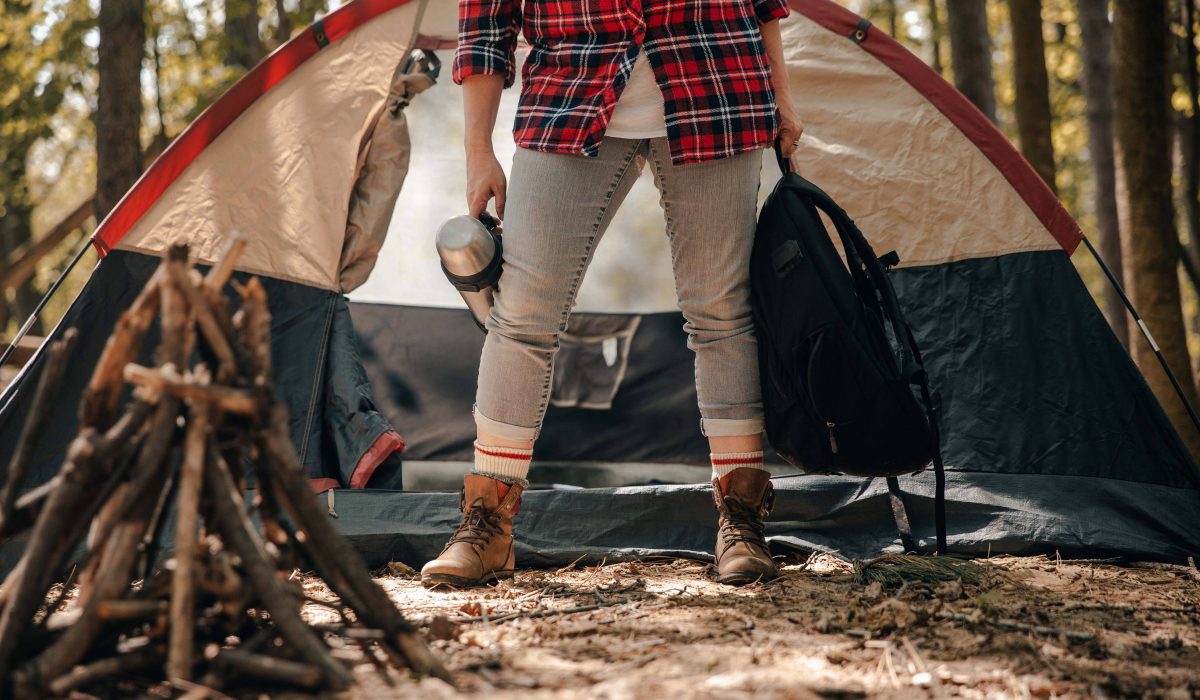 Camper a camper holding her backpacking gears