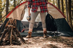 a camper holding her backpacking gears