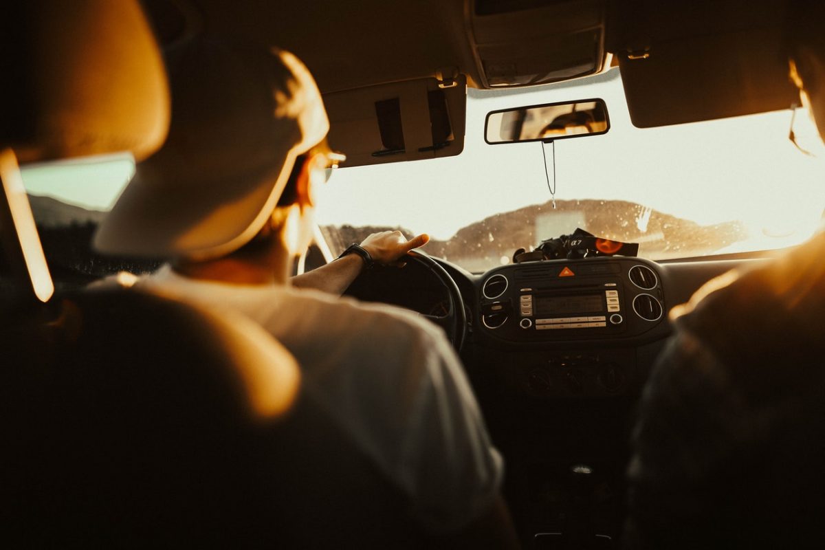 a man driving during sunset