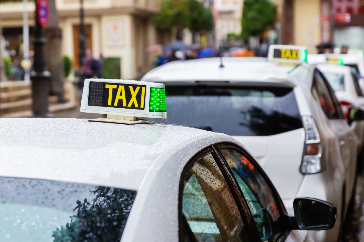 taxi with overhead green light in seville taxi with overhead green light in seville
