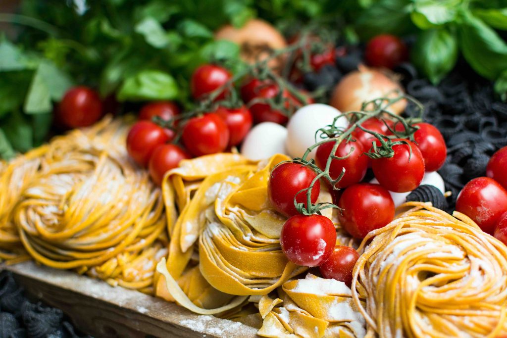 a close up shot of pre-cooked pastas, tomatoes and cheese