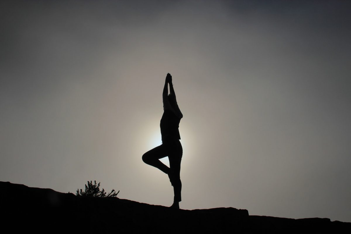 a silhouette of a woman doing a yoga pose