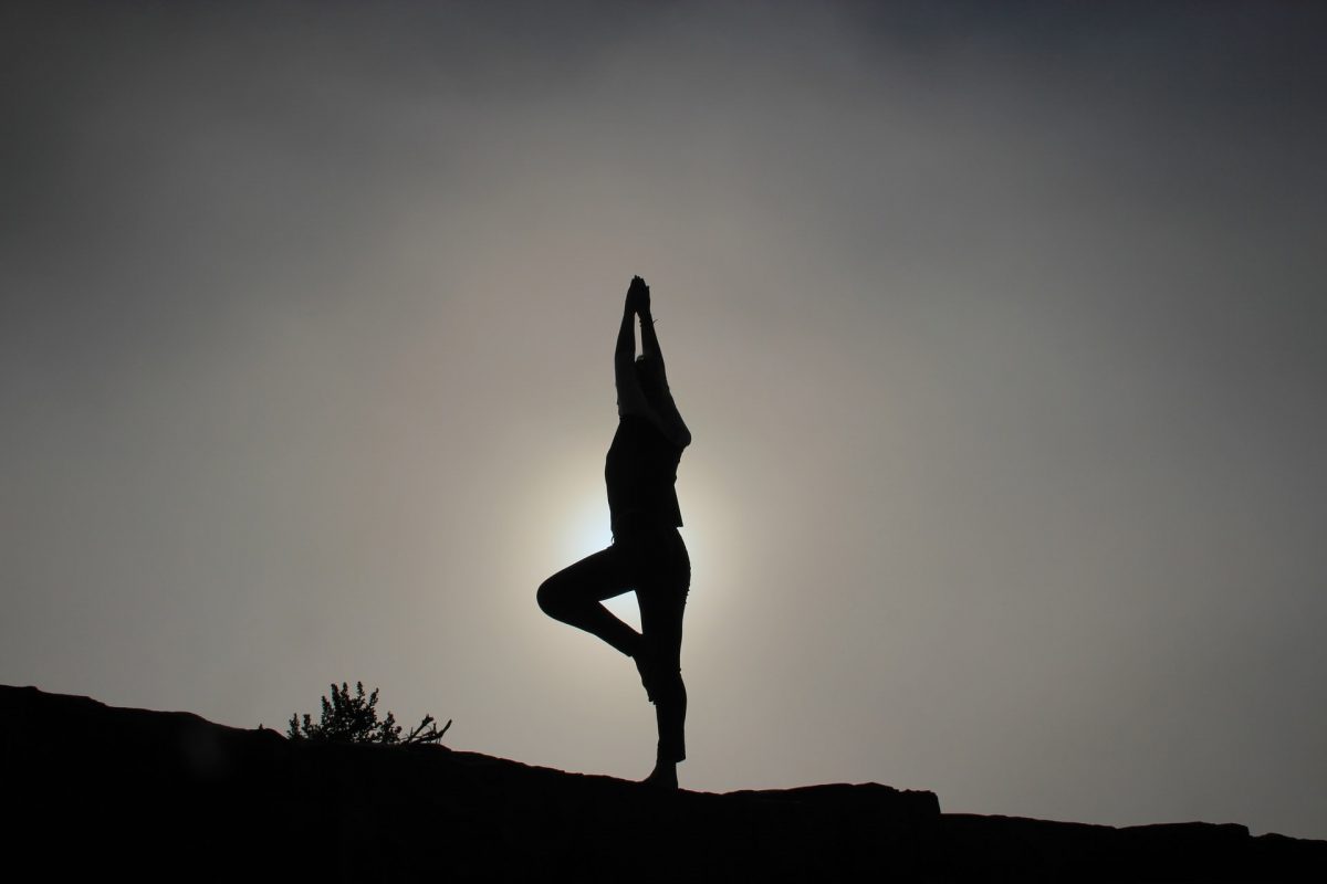 a silhouette of a woman doing a yoga pose a silhouette of a woman doing a yoga pose