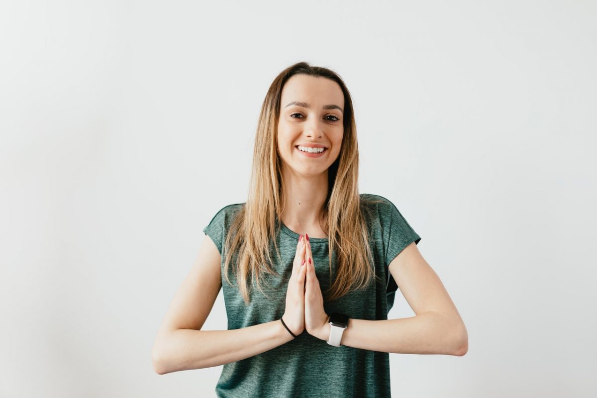 a woman showing how to properly say "namaste"