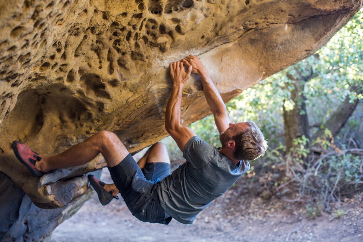 a man bouldering in a rock a man bouldering in a rock