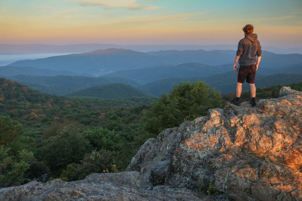 a man on a boulder appreciating the view at Shenandoah a man on a boulder appreciating the view at Shenandoah