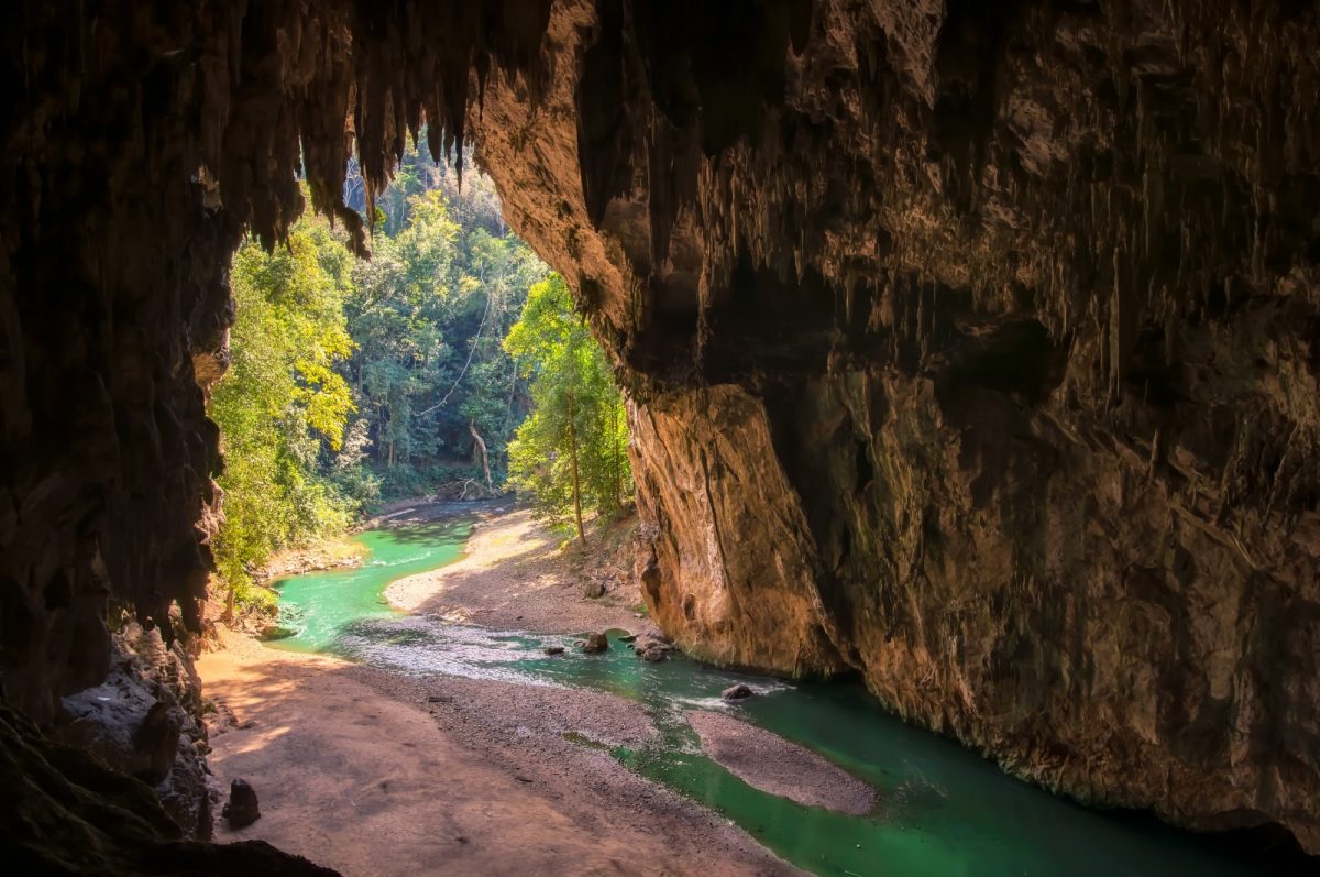 A river flowing towards a cave