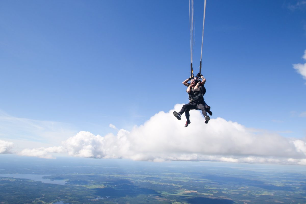 two people flying on a parachute two people flying on a parachute