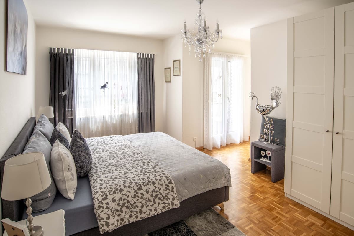 a luxurious bedroom with subtle French influence in an Airbnb in Switzerland a luxurious bedroom with subtle French influence in an Airbnb in Switzerland