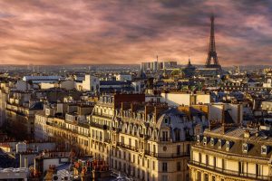 an aerial view of Paris' buildings and the Eiffel Tower