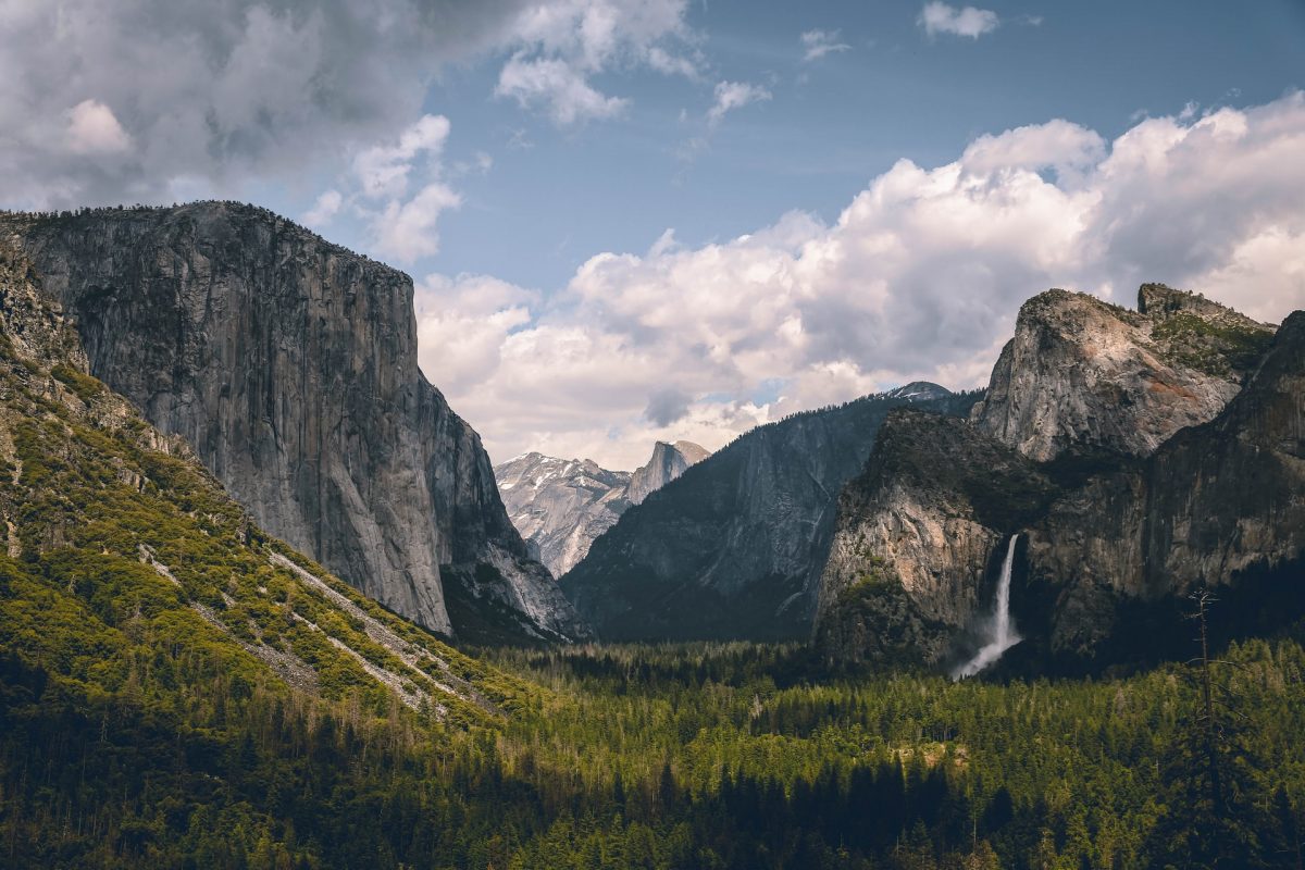 a car camping site with a spectacular view of the mountains, forests, and falls at Yosemite National Park