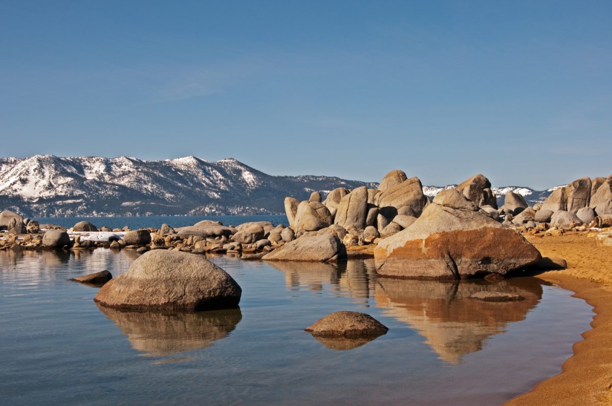 a beach filled with smooth boulders