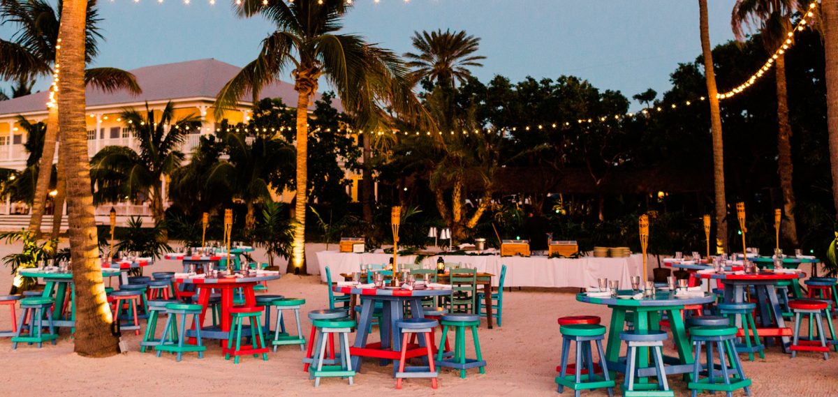colorful tables and stools on the sand