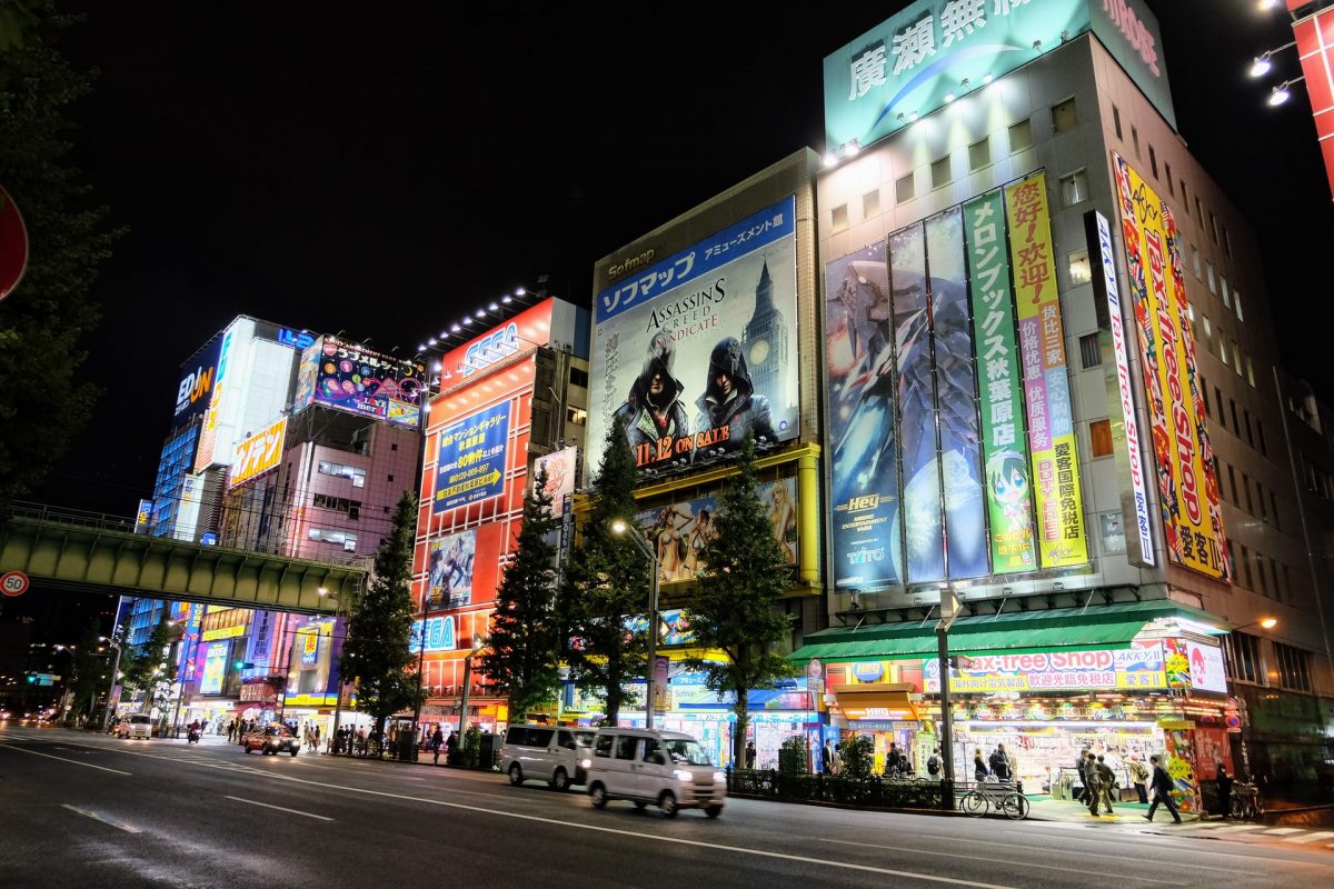 buildings in a district in tokyo with bright game billboards 