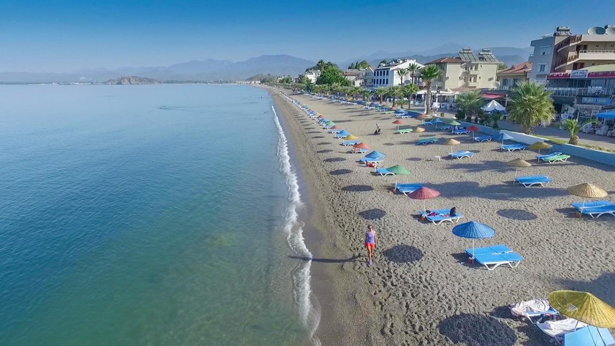 a shore lined with colorful umbrellas a shore lined with colorful umbrellas