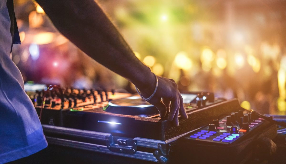 A DJ mixing songs for a more lively full moon party A DJ mixing songs for a more lively full moon party