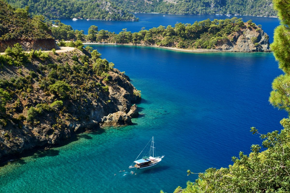 a boat cruising the turquoise fethiye bay a boat cruising the turquoise fethiye bay