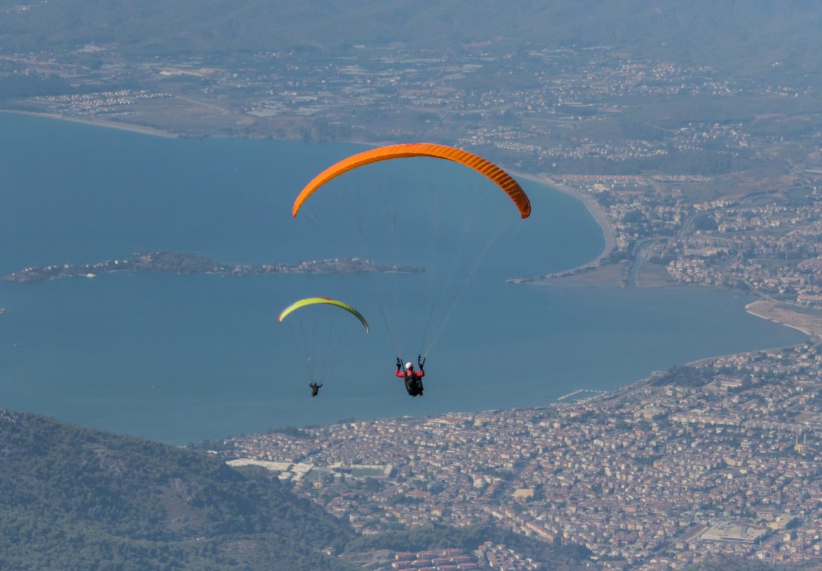 two paraglider soaring above the blue lagoon two paraglider soaring above the blue lagoon