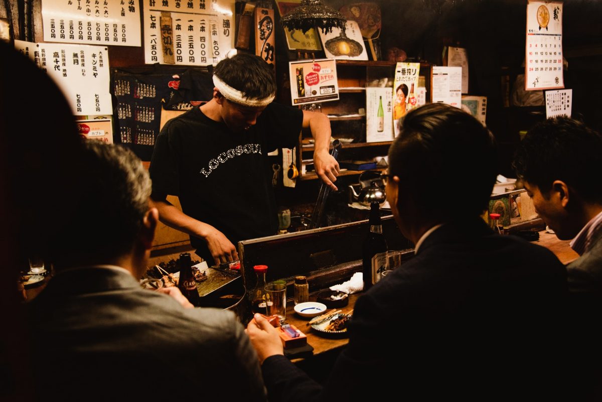 three men dining in the nightlife district of tokyo