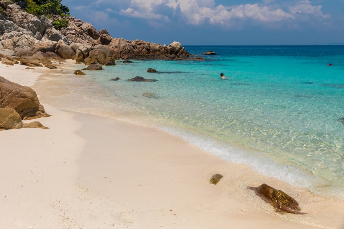 a woman swimming on the turquoise waters