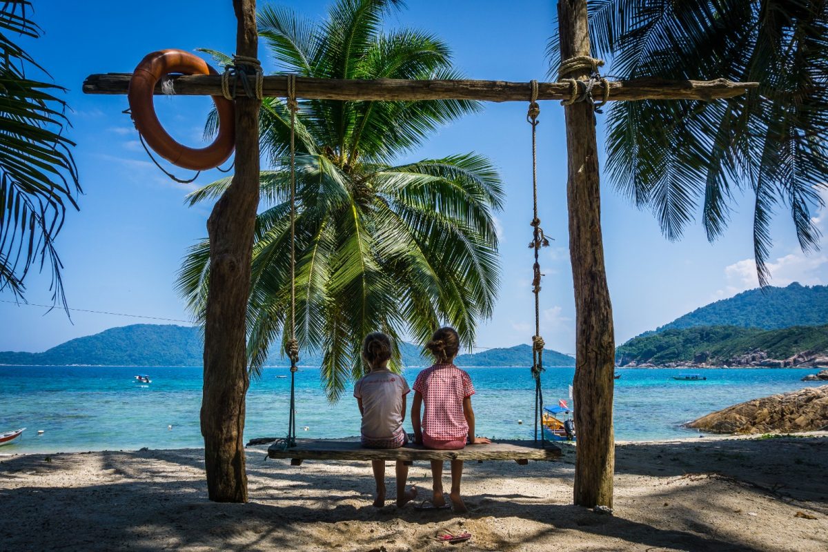 two girls on a swing