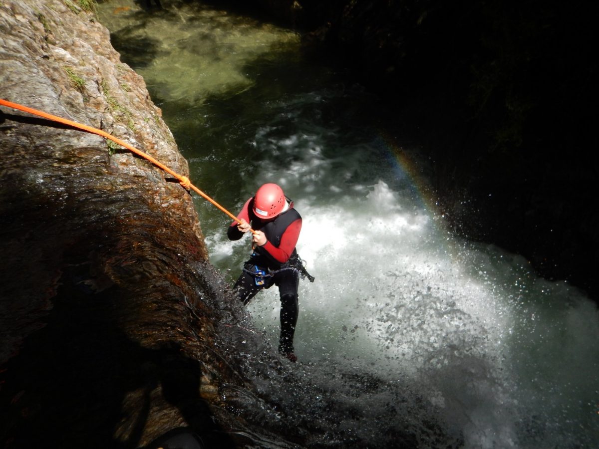 a person abseiling in a gorge