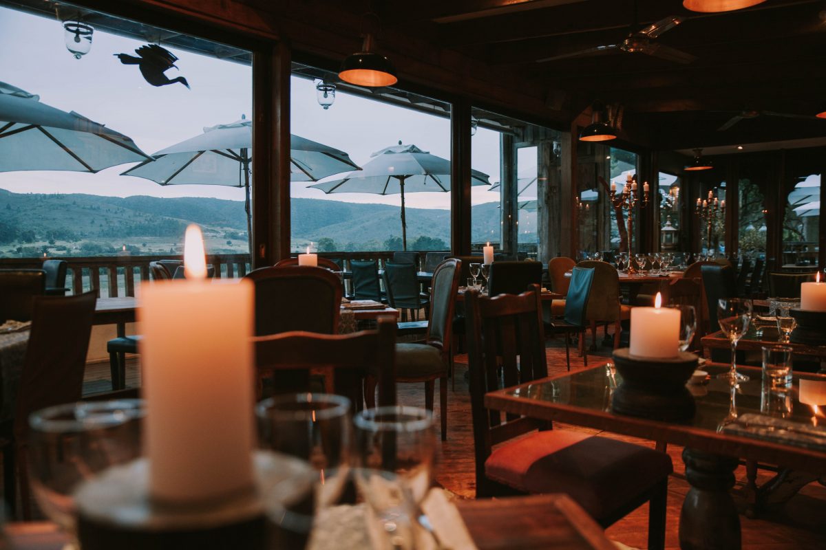 a rustic restaurant with a view of south african mountains