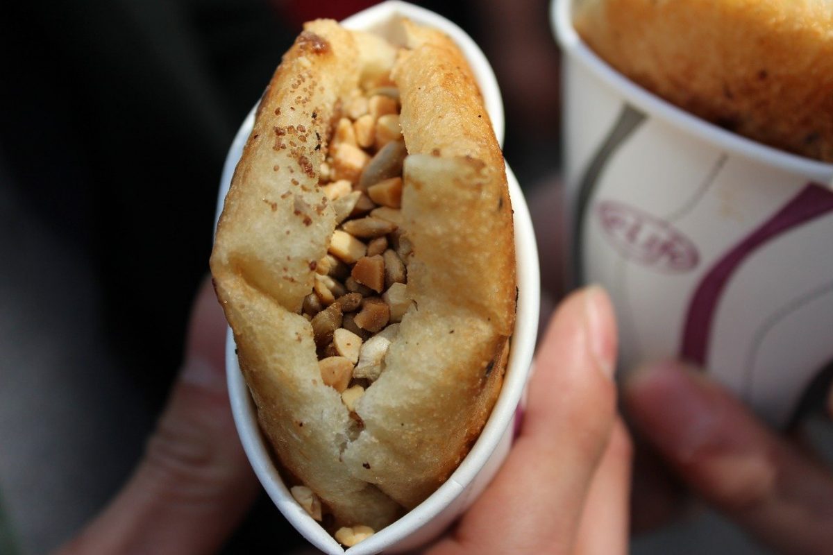 a hotteok with seeds placed in a cup a hotteok with seeds placed in a cup