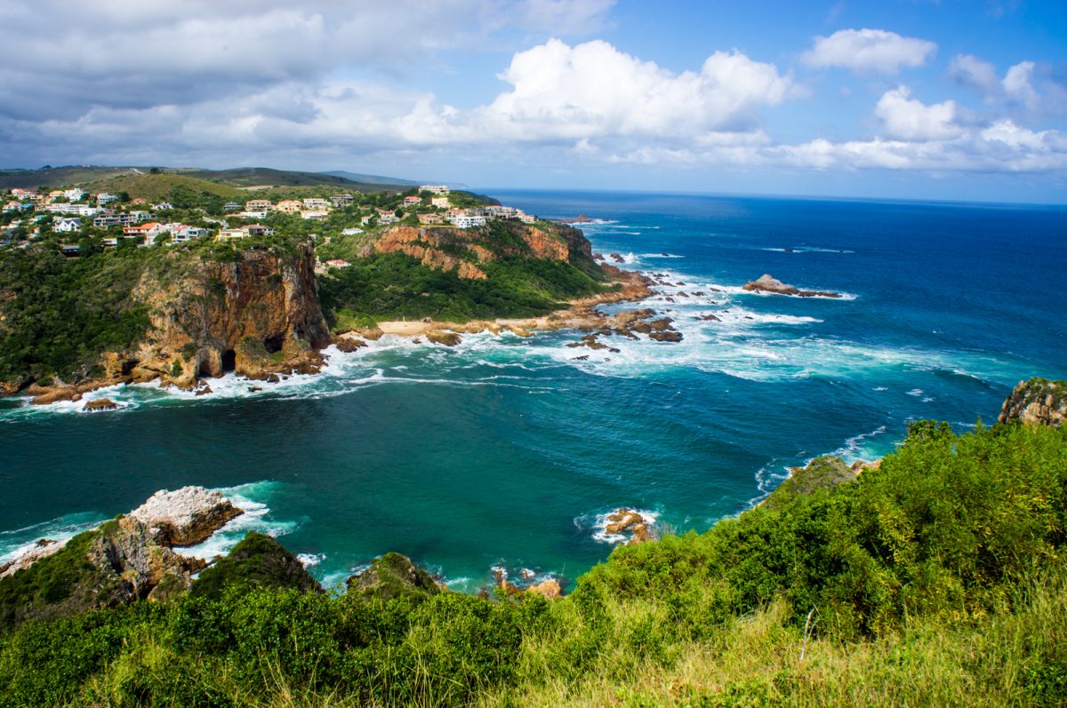 rugged cliffs on top of garden route's azure waters
