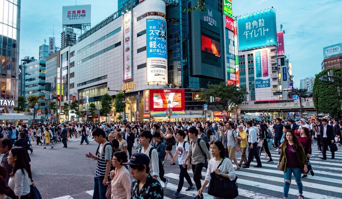 Locals and tourists crossing the street in Tokyo