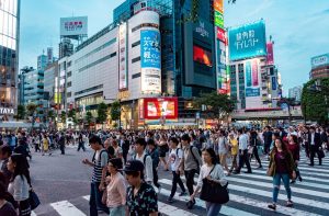 Locals and tourists crossing the street in Tokyo