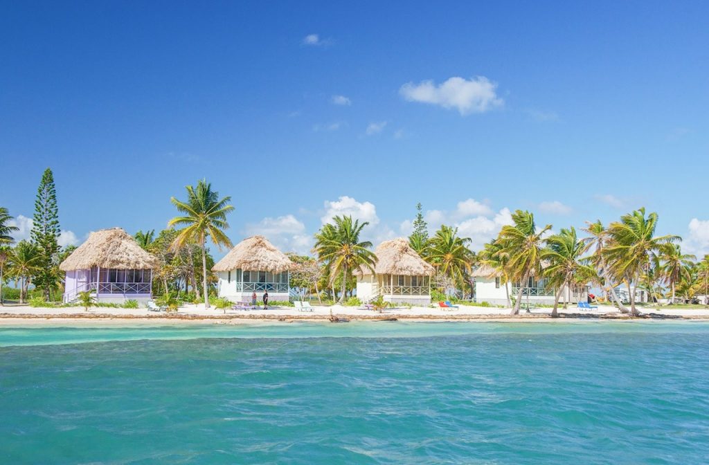 View of the Blackbird Caye Resort cabanas from the beach