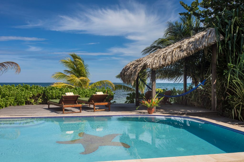 View of one of Turtle Inn's poolside cottages