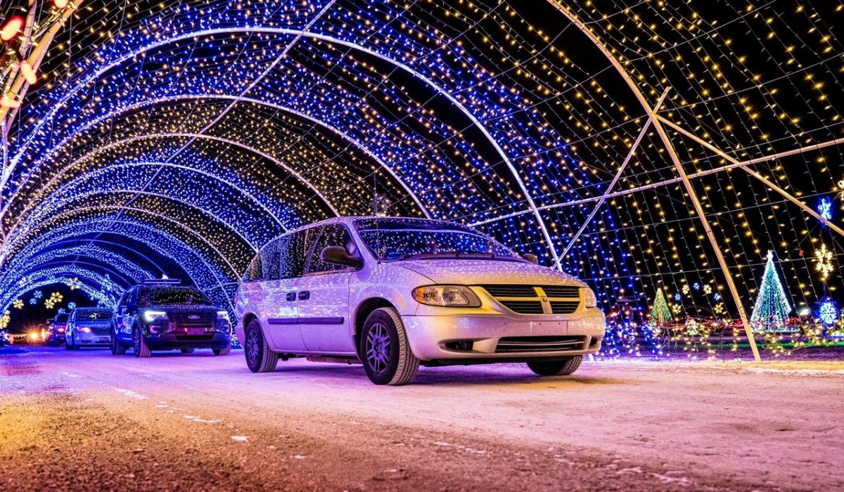 Cars passing through the tunnel at a drive thru Christmas lights show